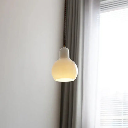 Minimalist off-white ceramic led pendant lamp with a rounded shape and warm glow for dining room lighting