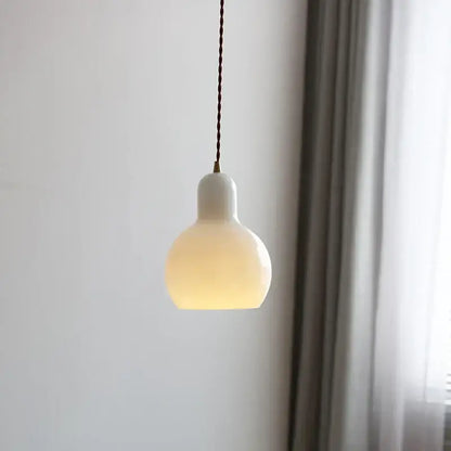 Minimalist white ceramic led pendant lamp with warm glow and twisted brown cord ideal for dining room lighting