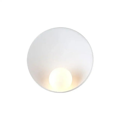 Minimalist white ceramic led wall sconce with frosted glass and warm glowing bulb for bedroom lighting