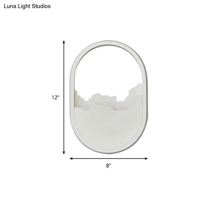 White oval mirror with minimalist frame and abstract mountain design featuring a white cloud led wall sconce wall lamp 220v-240v 110v-120v