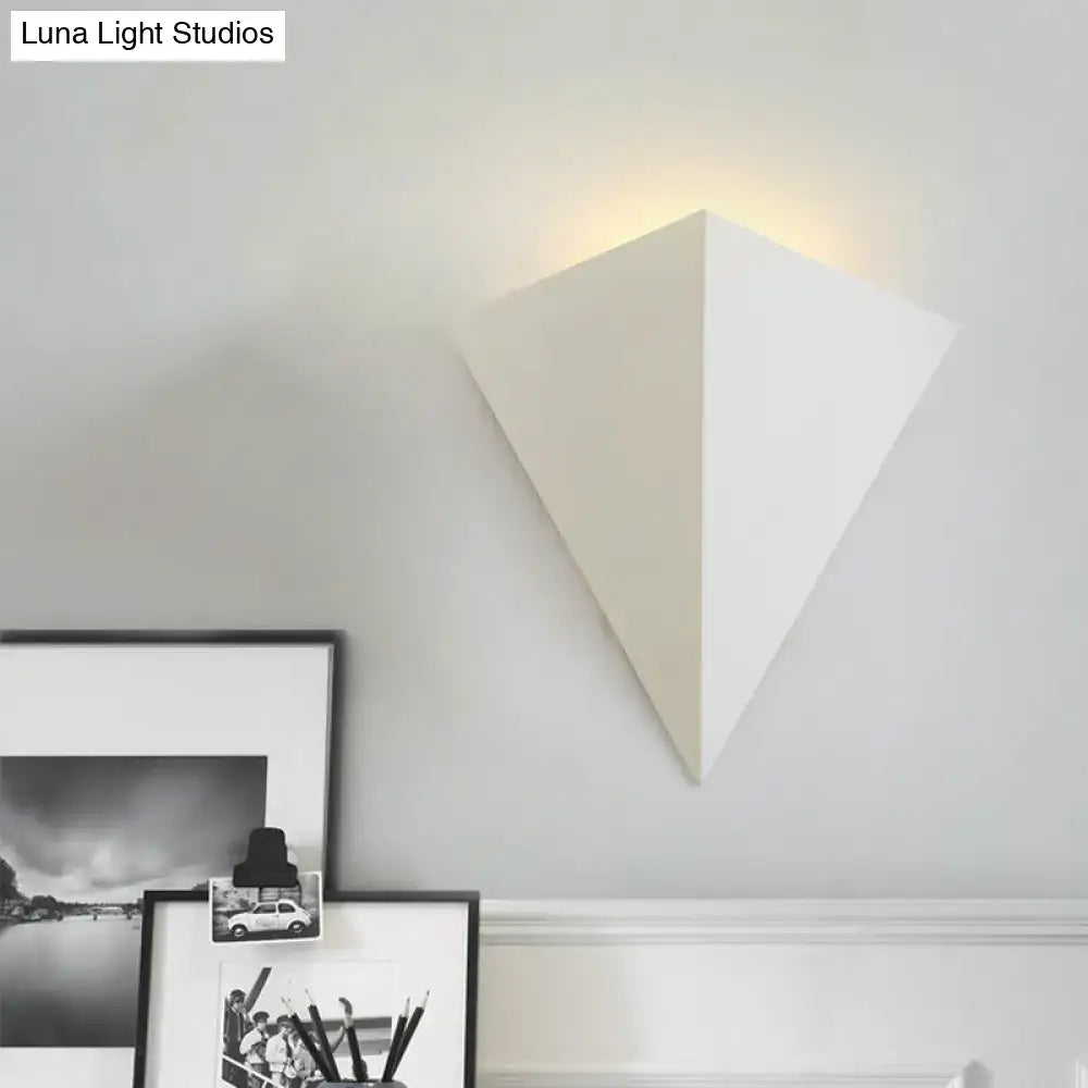White geometric wall lamp with minimalist triangular cone design ideal for living room decor lighting