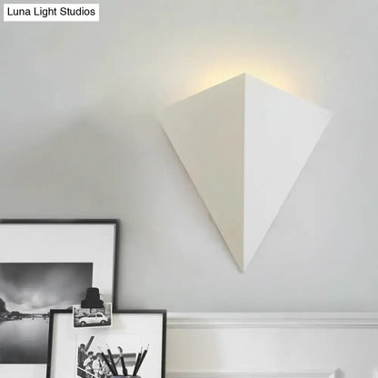 White geometric wall lamp with minimalist triangular cone design ideal for living room decor lighting