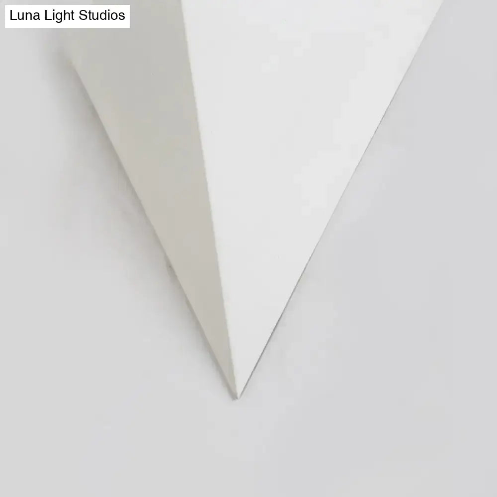 A sleek minimalist white cone led wall lamp with a smooth triangular canvas for modern living room decor