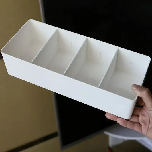 White rectangular plastic divided storage box with three compartments for minimalist kitchen tableware organization