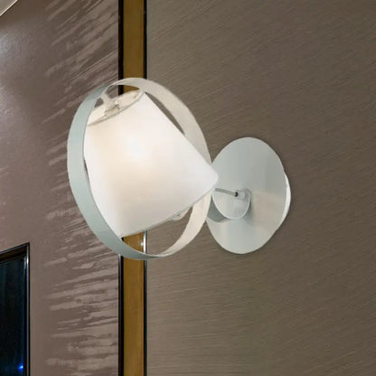Minimalist white fabric wall light with a metal ring and soft shade designed as a bedroom wall sconce