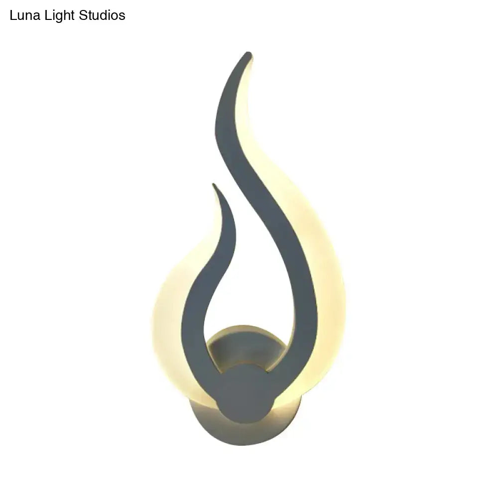 Minimalist white flame wall sconce with sleek black silhouette and warm glowing led light for bedroom use
