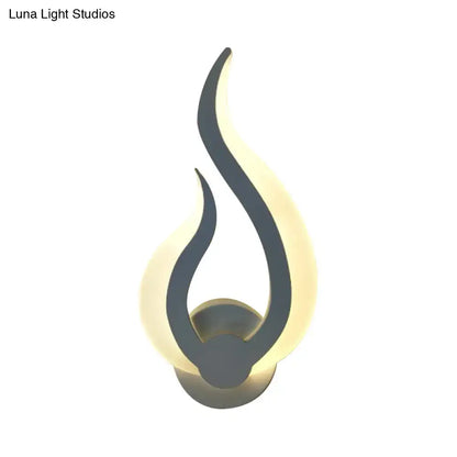 Minimalist white flame wall sconce with sleek black silhouette and warm glowing led light for bedroom use