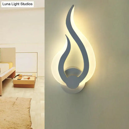Minimalist white flame wall sconce with sleek gray design emitting warm ambient LED light for bedroom use