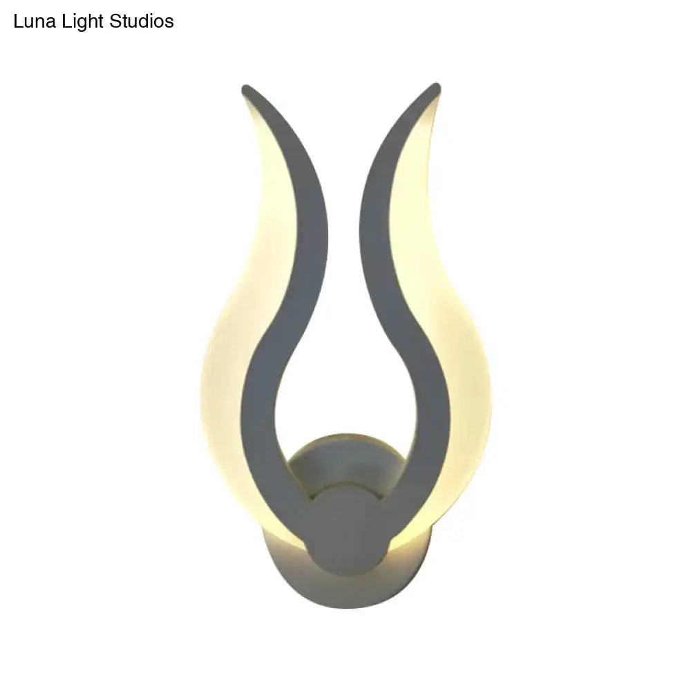 Minimalist white flame wall sconce with sleek gray finish and warm glowing LED light for bedroom use