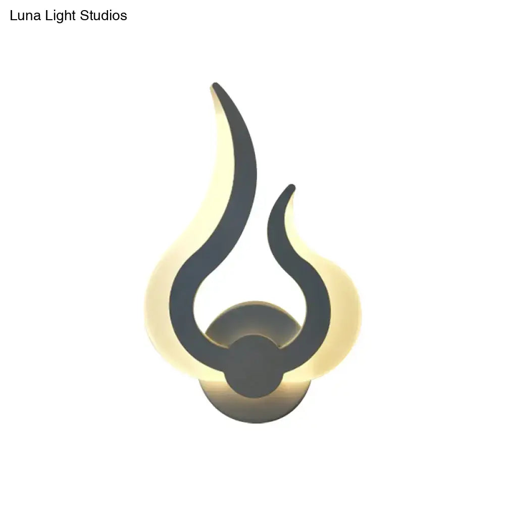 Minimalist white flame wall sconce with sleek black finish and warm ambient led lighting for bedroom use