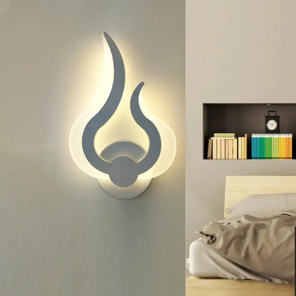 Minimalist white flame wall sconce with sleek gray accents emitting warm ambient LED light for bedroom use