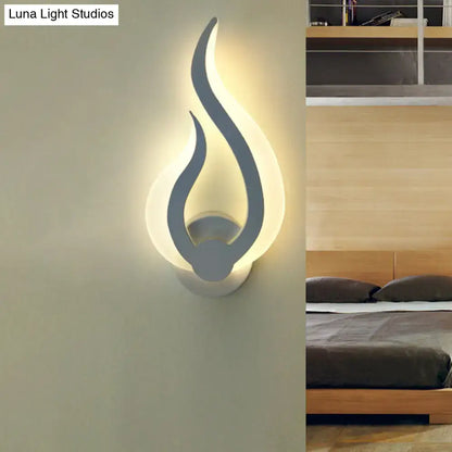 Minimalist white flame wall sconce in matte gray with warm white LED light for modern bedroom decor