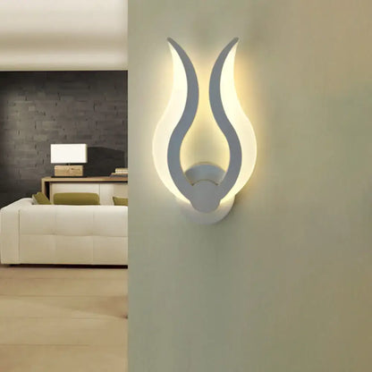 Minimalist white flame-shaped led wall sconce with sleek modern design for bedroom lighting