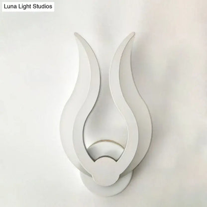Minimalist white flame wall sconce with sleek minimalist design and LED light for bedroom use