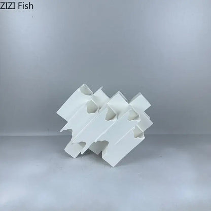 Minimalist white geometric ceramic desk ornament featuring interlocking design as decorbites geometric ceramic decor