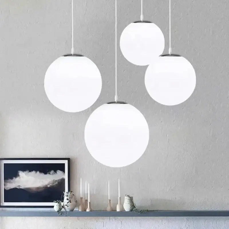 Set of four minimalist white glass ball pendant lights with frosted shades and metal fixtures for dining room decorbites glass ball