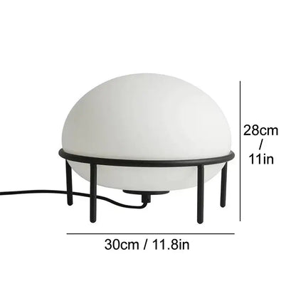 Minimalist white glass ball table lamp with frosted dome on a black metal frame ideal for modern decorbites glass ball decor