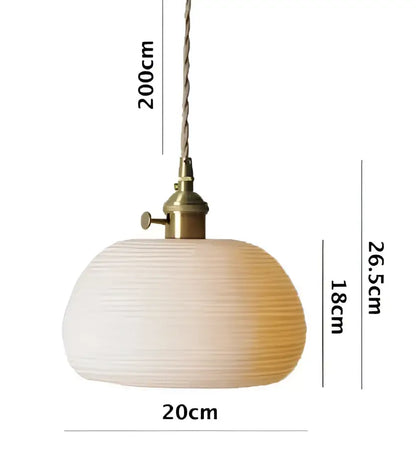 Minimalist white glass pendant light with ribbed design and brass fixture ideal for dining room pendant lights