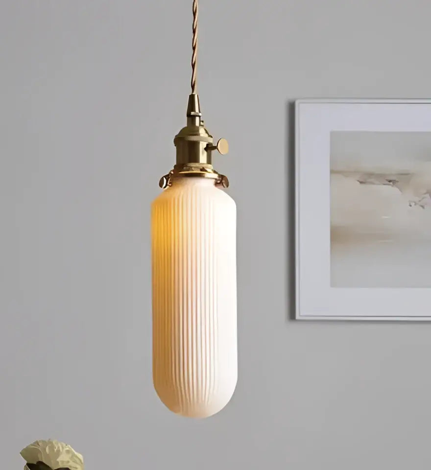 Minimalist white glass pendant lights with warm-toned ribbed glass and brass fixture for dining room lighting