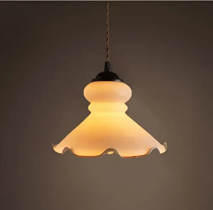 Minimalist warm-toned frosted glass pendant light with scalloped edge and black metal fixture for dining room pendant lights