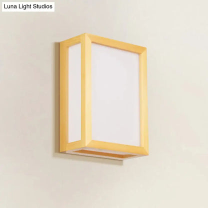 Minimalist wall sconce with white glass diffuser and wooden frame designed for corridor lighting