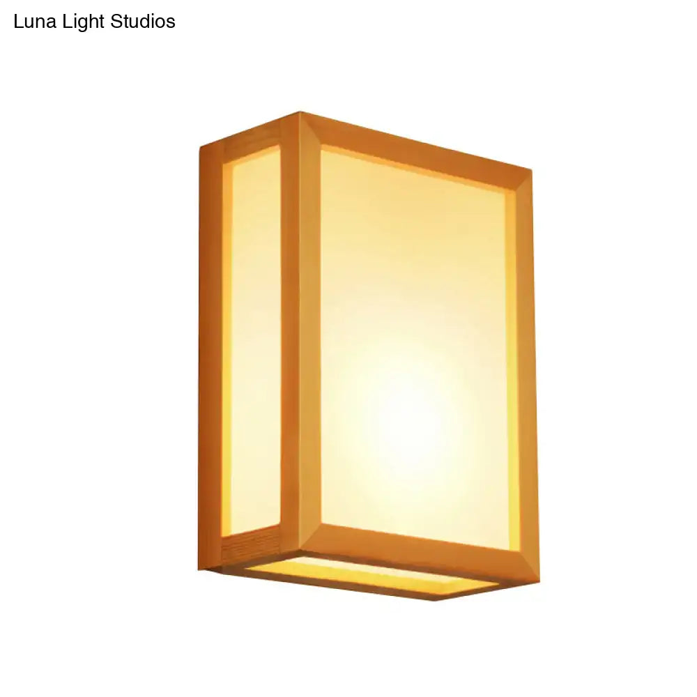 Minimalist wall sconce with warm-toned white glass and wooden frame designed for corridors