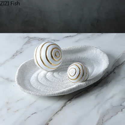 Minimalist white ceramic tray with textured spiral ridges and two white golden texture balls for geometric desk decoration