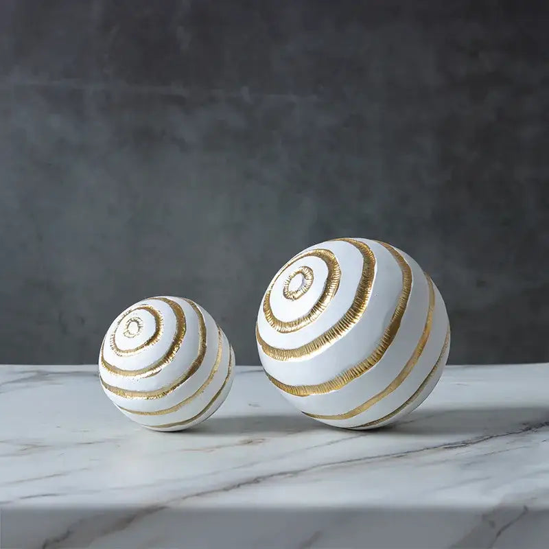 Minimalist white ceramic spheres with gold metallic spiral stripes geometric desk decoration and golden texture ball
