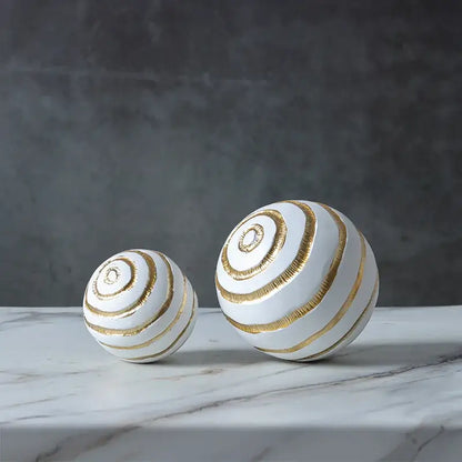 Minimalist white ceramic spheres with gold metallic spiral stripes geometric desk decoration and golden texture ball