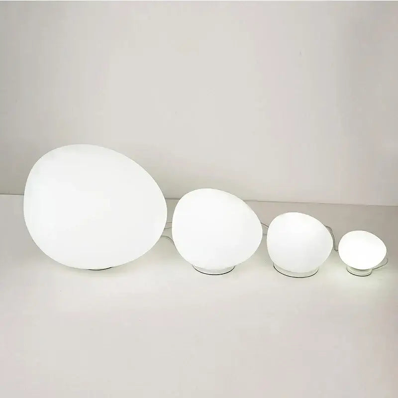 Set of four white minimalist goose egg led floor lamps with frosted glass shades and metallic bases for bedroom decorbites