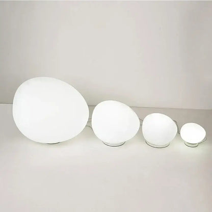 Set of four white minimalist goose egg led floor lamps with frosted glass shades and metallic bases for bedroom decorbites