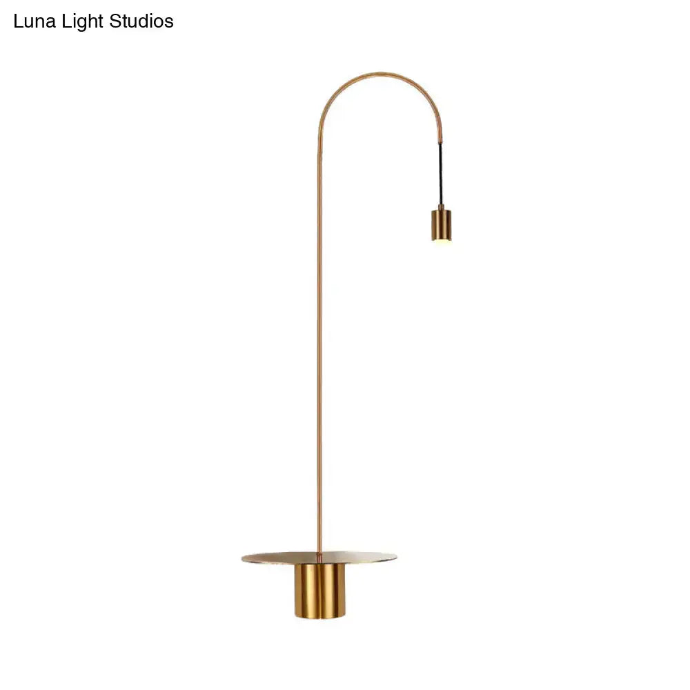 Minimalist white gooseneck wall sconce with shelf wall light featuring a sleek brass curved floor lamp design