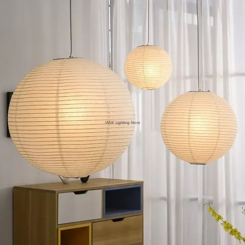 Three minimalist white handwoven art pendant lamps with warm glowing light and horizontal ridges for living room decorbites handwoven art