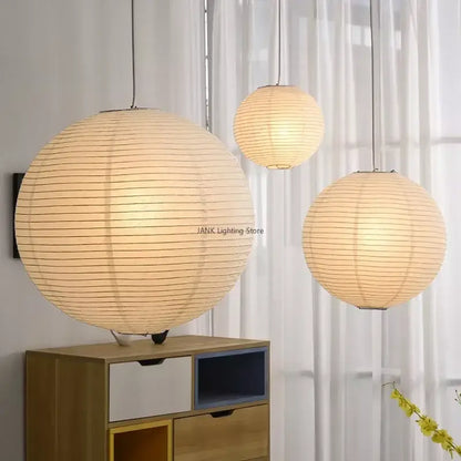 Three minimalist white handwoven art pendant lamps with warm glowing light and horizontal ridges for living room decorbites handwoven art