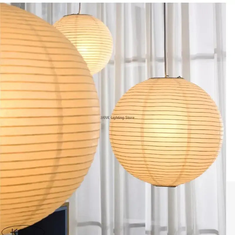 Minimalist white handwoven art pendant lamp with warm-toned spherical paper lanterns by decorbites handwoven art