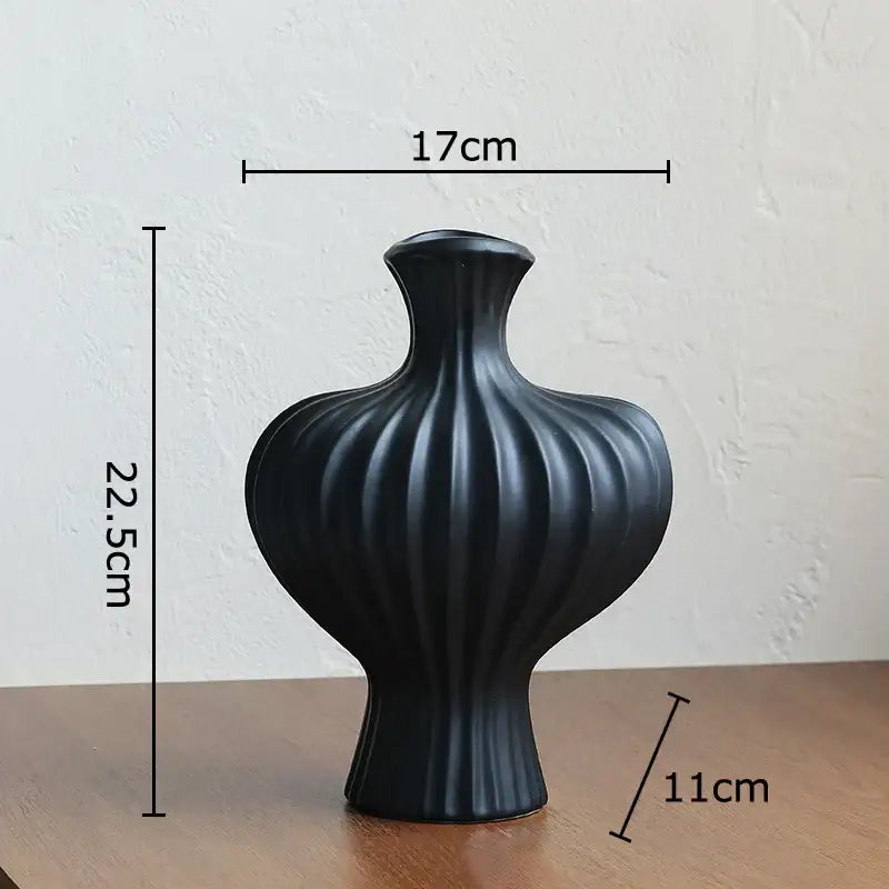 Black ceramic vase with vertical ribbed texture and flared neck for minimalist white heart shape ceramic decorbites heart shape decor