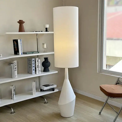 Minimalist white led floor lamp with a sculpted tapered base for modern living room lighting