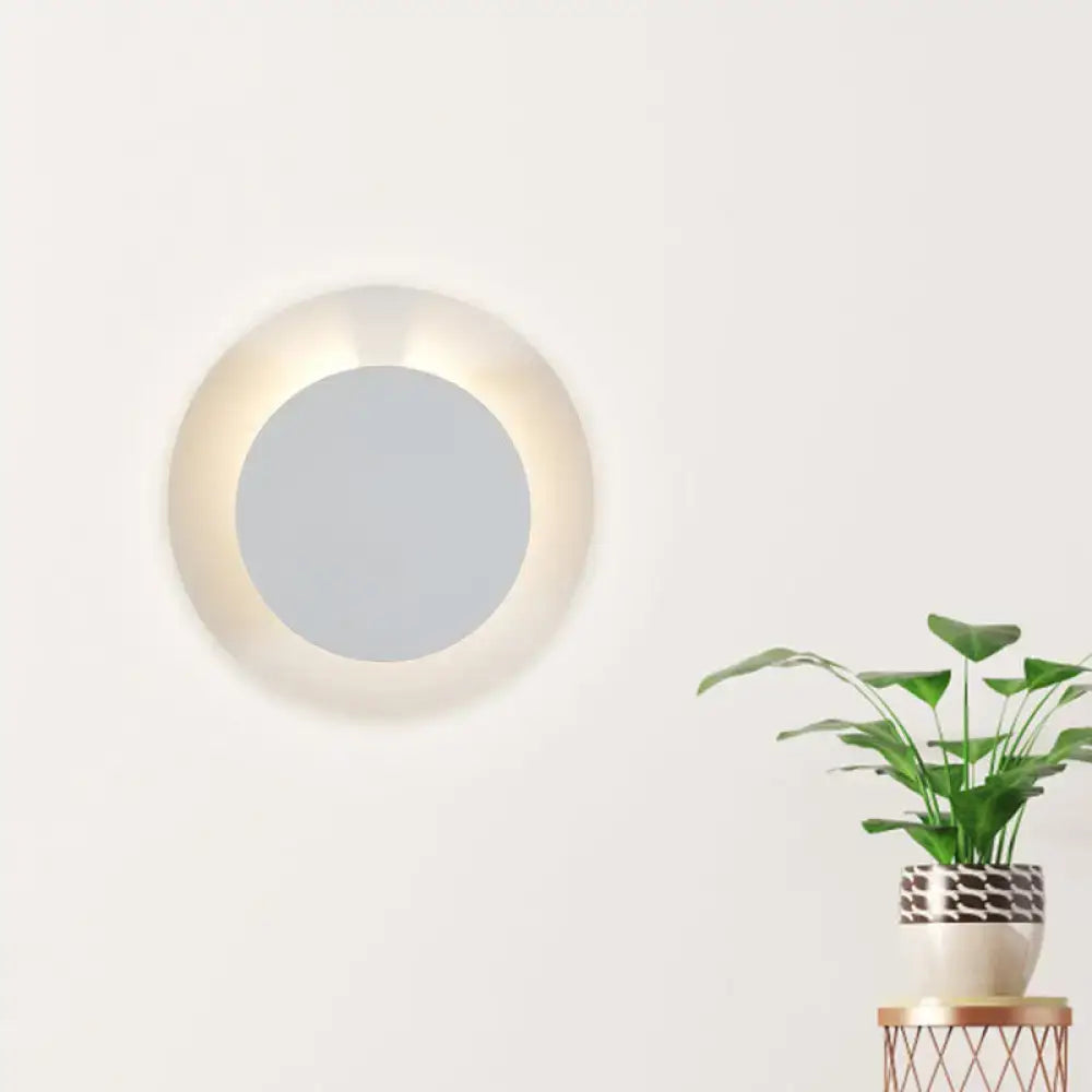Minimalist white led circular wall sconce lamp with softly glowing illuminated frame for bedroom lighting