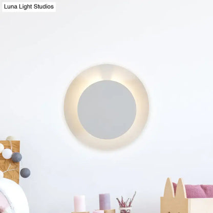 Minimalist white led circular wall sconce lamp with warm glowing ring for bedroom light fixture