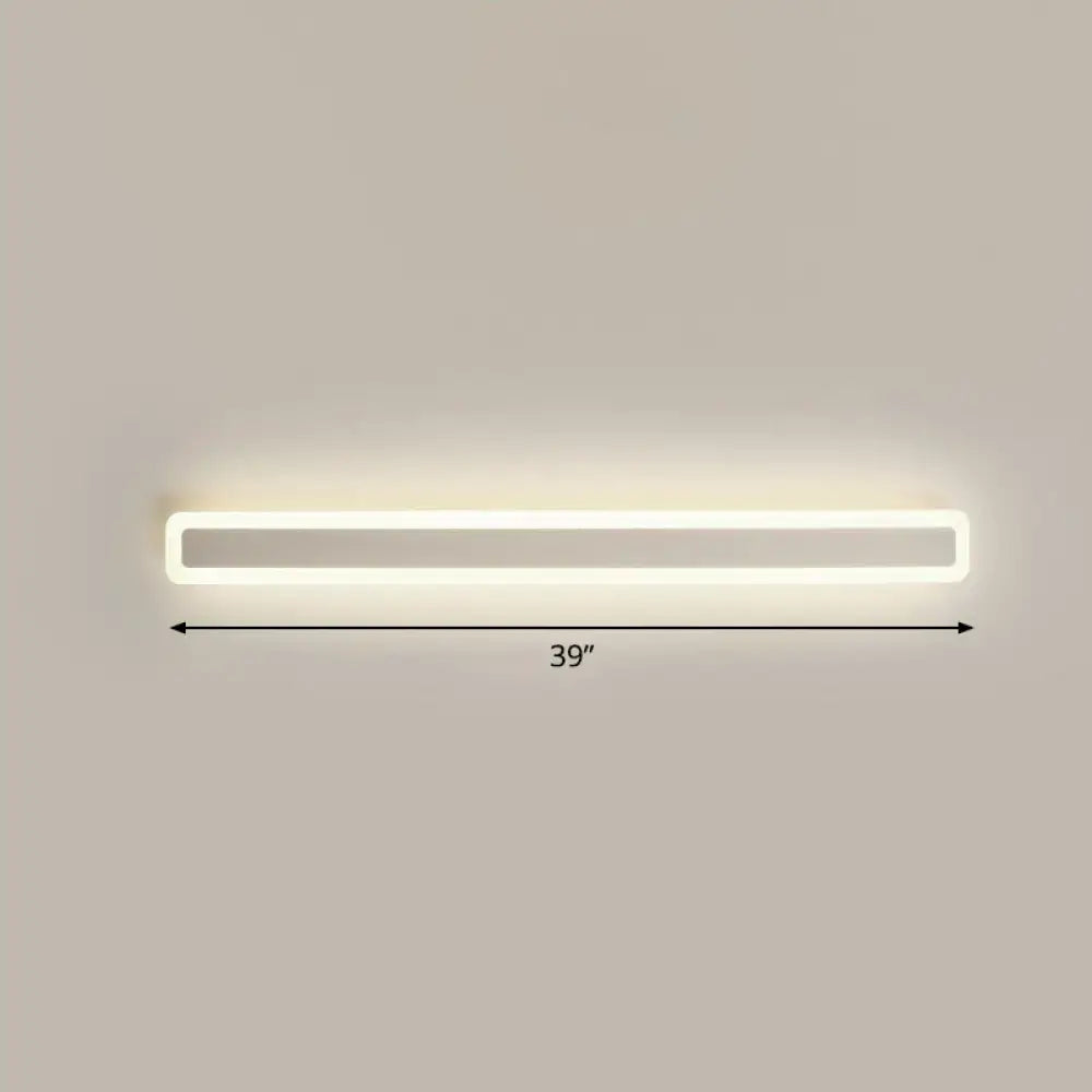 A sleek minimalist white led vanity light wall sconce with warm third gear soft white illumination for bathrooms