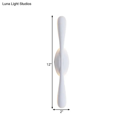 Minimalist white linear wall sconce lighting with sleek curved arms for modern living room decor
