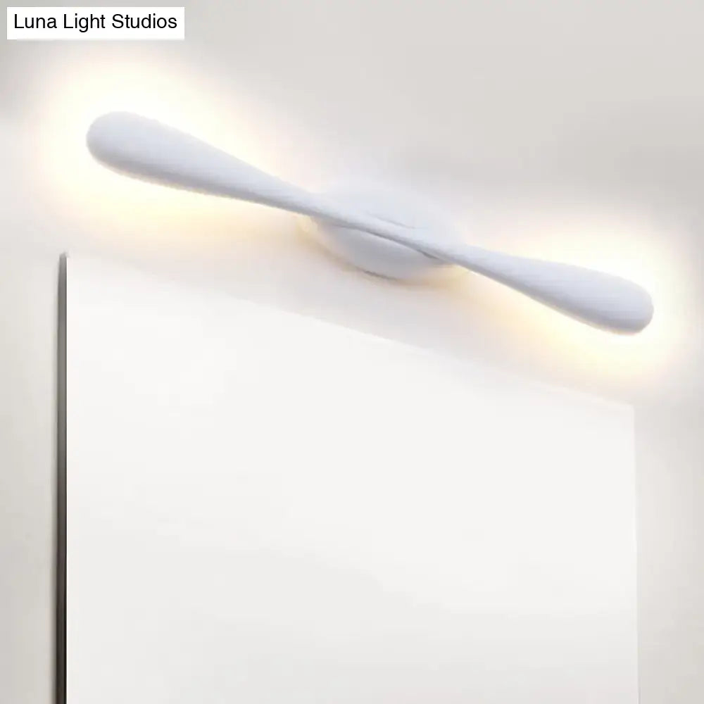 Minimalist white linear wall sconce lighting with a sleek curved design for modern living room decor