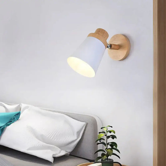 Minimalist white metal barrel wall lamp with a conical shade and natural wood accents as a living room wall lamp sconce