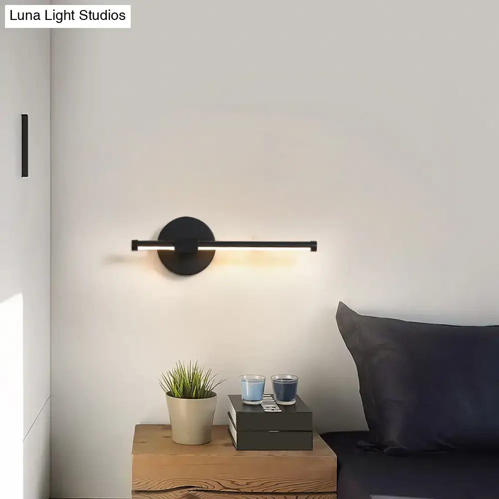 Black minimalist wall sconce with circular base and horizontal light bar for wall mount lighting maximum bulb wattage use