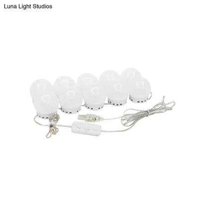 Minimalist white oval led vanity strip with eight spherical bulbs and usb-powered remote control for dressing room lighting
