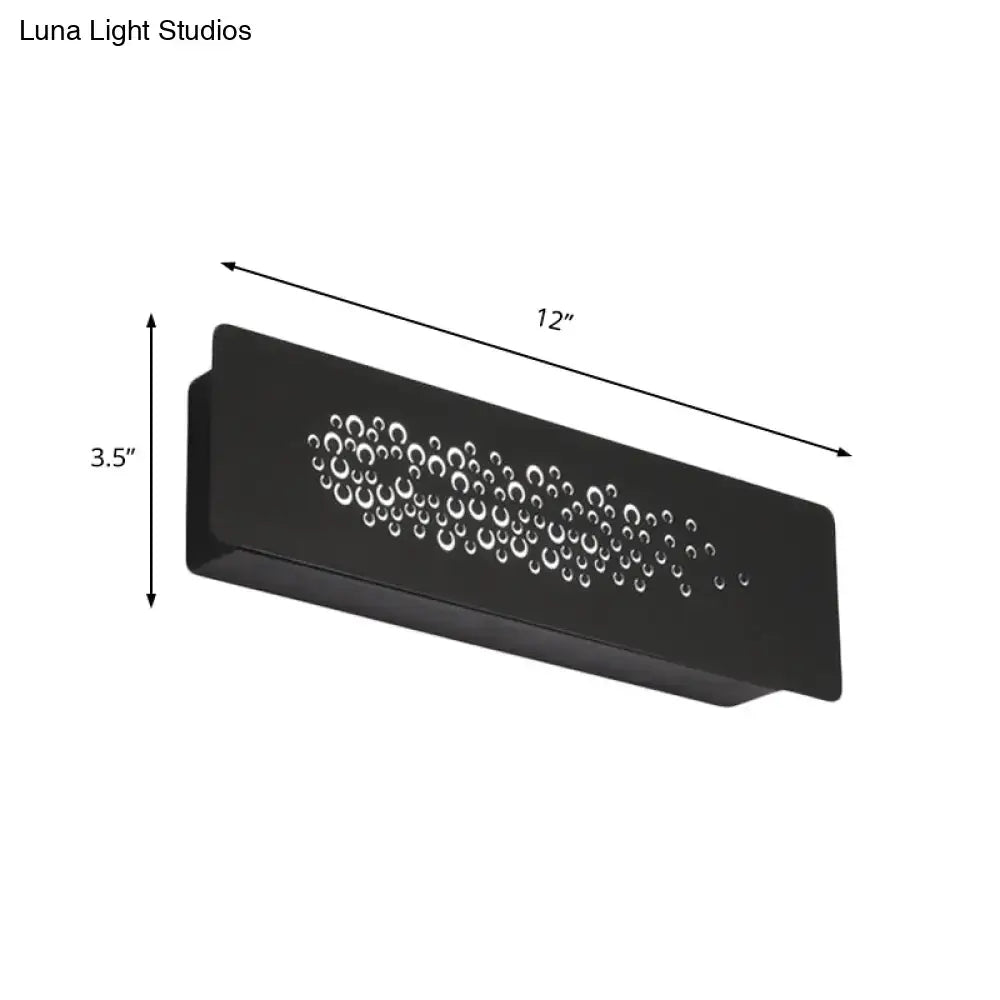 Black rectangular minimalist wall lamp with sturdy metal design and circular cutouts for bedroom up and down light