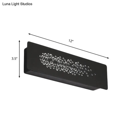 Black rectangular minimalist wall lamp with sturdy metal design and circular cutouts for bedroom up and down light