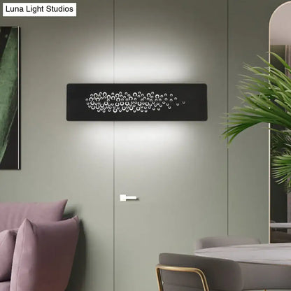 Minimalist black wall lamp with sturdy metal frame and white circular cutouts for bedroom up and down light type