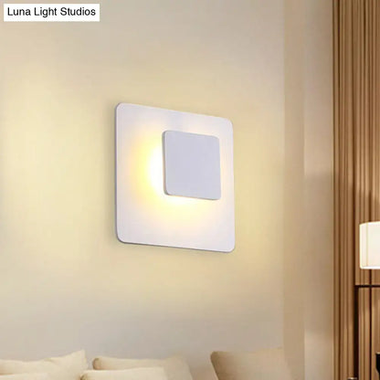 Minimalist white square led sconce lighting with recessed panel emitting white warm light for bedroom use