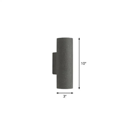 Gray concrete outdoor wall sconce with 10-inch fixture height and minimalist white terrazzo stair design